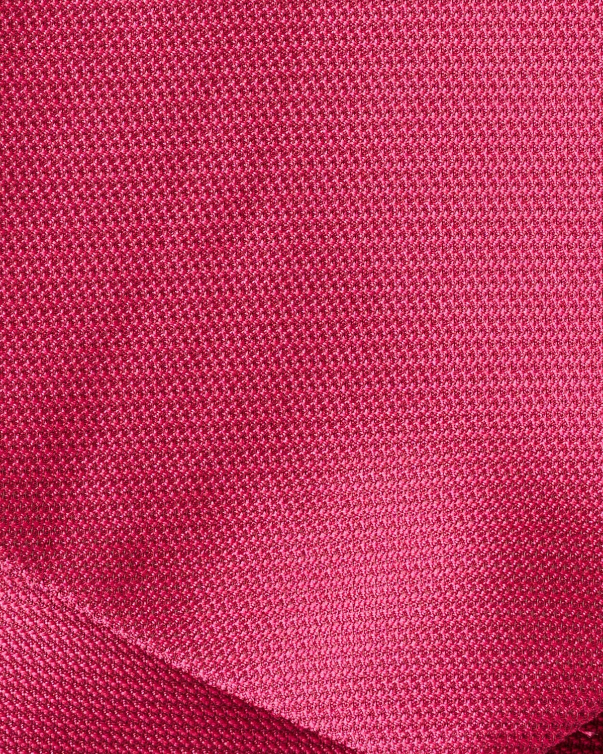 Bright rose textured fabric close-up with fine woven pattern