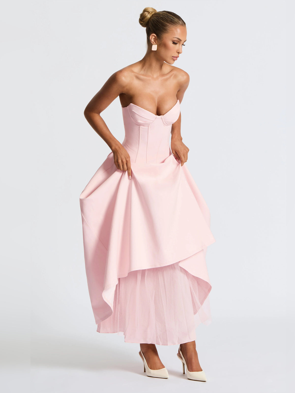 Blush pink strapless midi formal dress with asymmetrical layered skirt and corset bodice