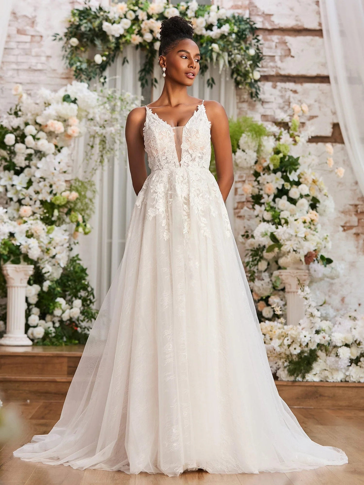 Ivory sleeveless V-neck A-line wedding dress with embroidered lace and flowing tulle skirt