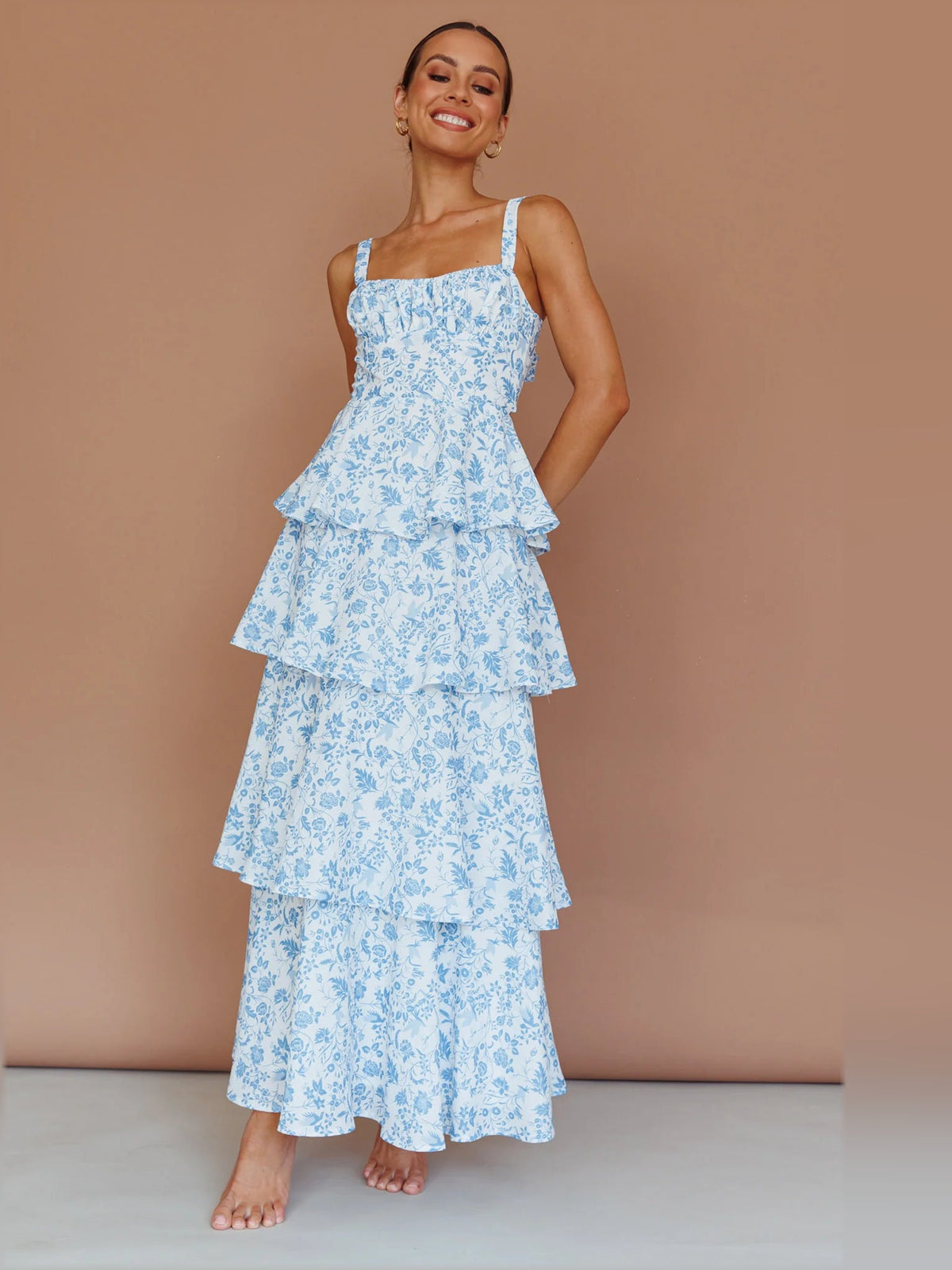 Blue floral tiered midi dress with ruffled tiers and spaghetti shoulder straps