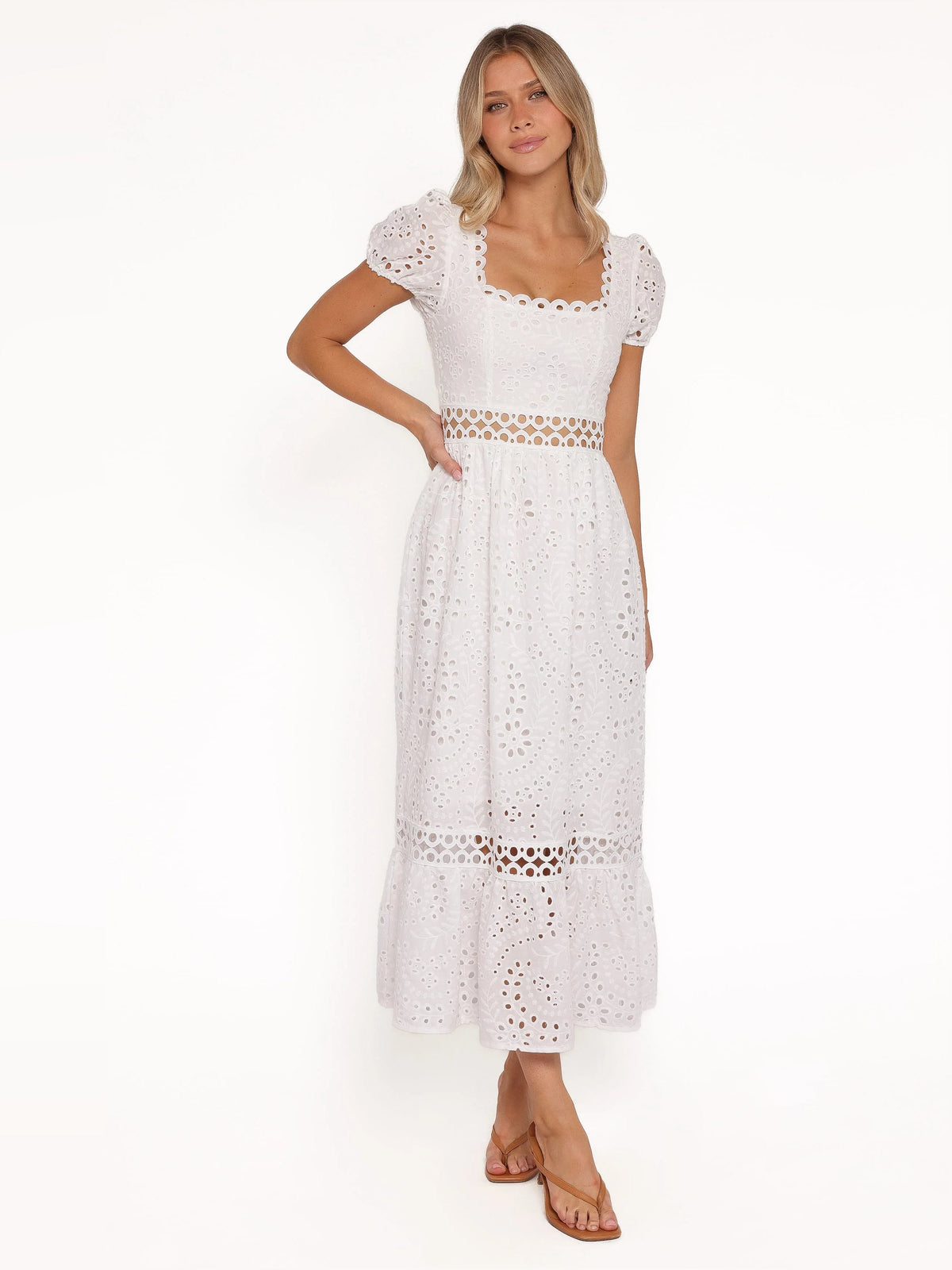 White midi formal dress with puff sleeves, square lace neckline, and tiered eyelet skirt