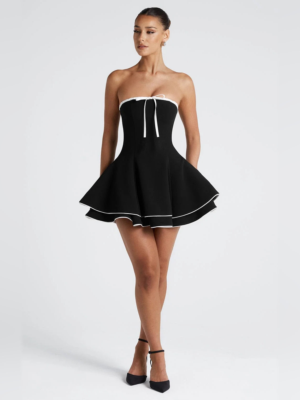 Mini homecoming dress: strapless black with white trim, ribbon tie, short flared skirt