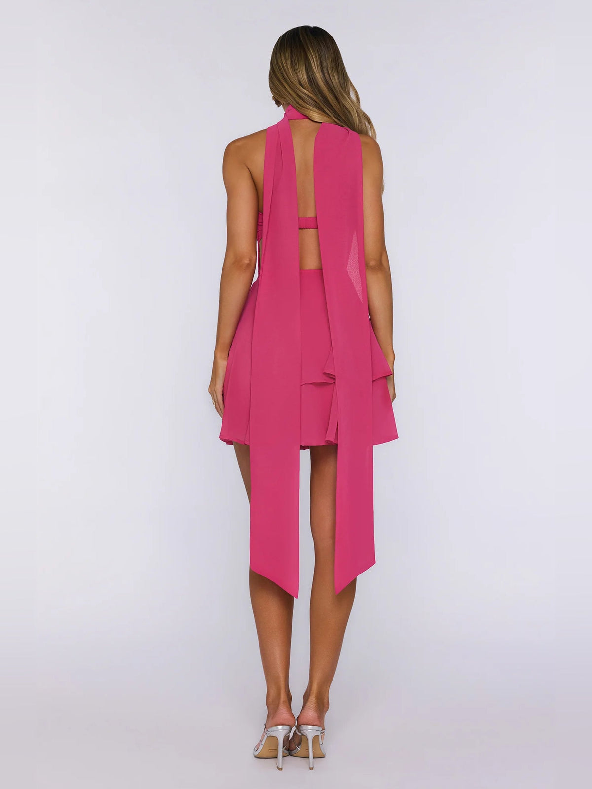 Magenta strapless mini dress, back view, showing center cutout and ribbon panels