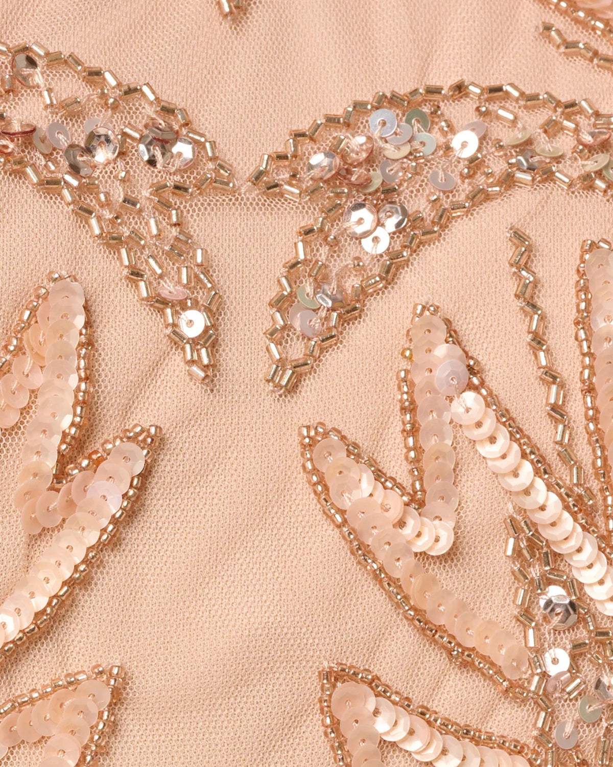 Close-up of rose gold beaded embroidery with sequins and chain-like embellishments