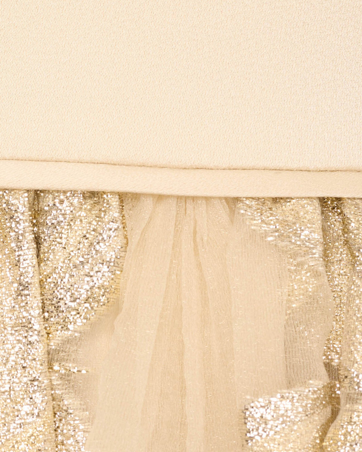 Close-up of gold beaded detail on a sheer waist panel of the V-neck gown