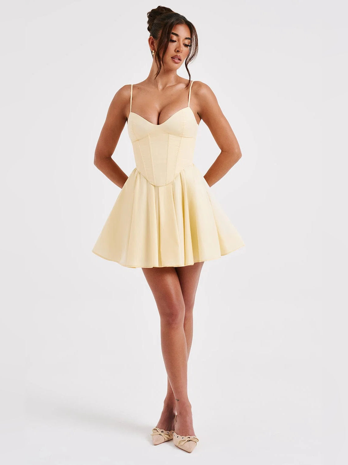 Lemon mini dress with thin straps and pleated skirt, corset-style bodice