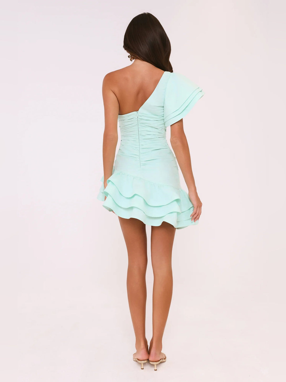 Mint one-shoulder mini dress from back with ruched waist and tiered ruffle hem