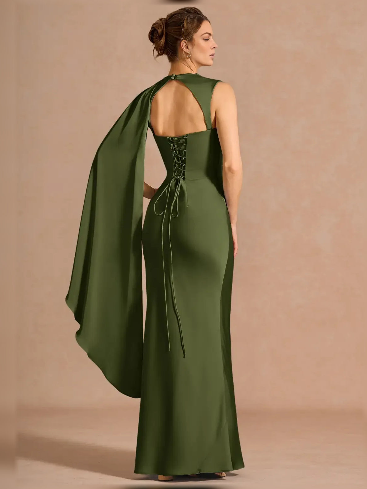 Moss green one-shoulder formal dress with open back and flowing draped cape panel