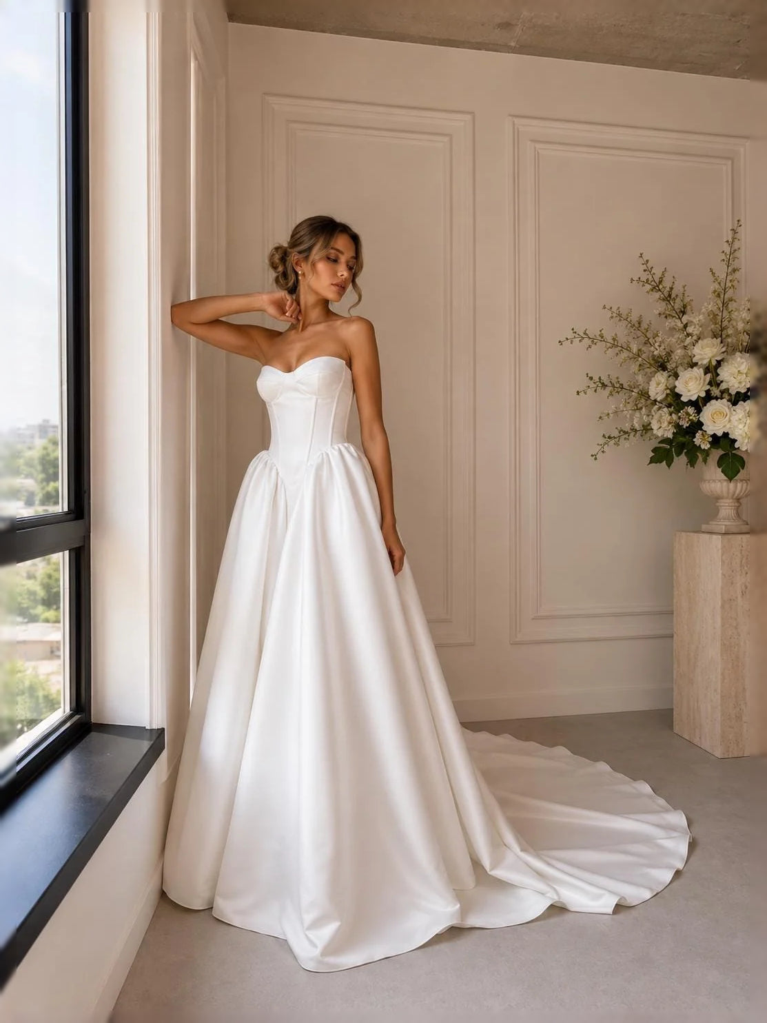 Ivory satin strapless sweetheart corset wedding gown with full pleated skirt, sweeping hem