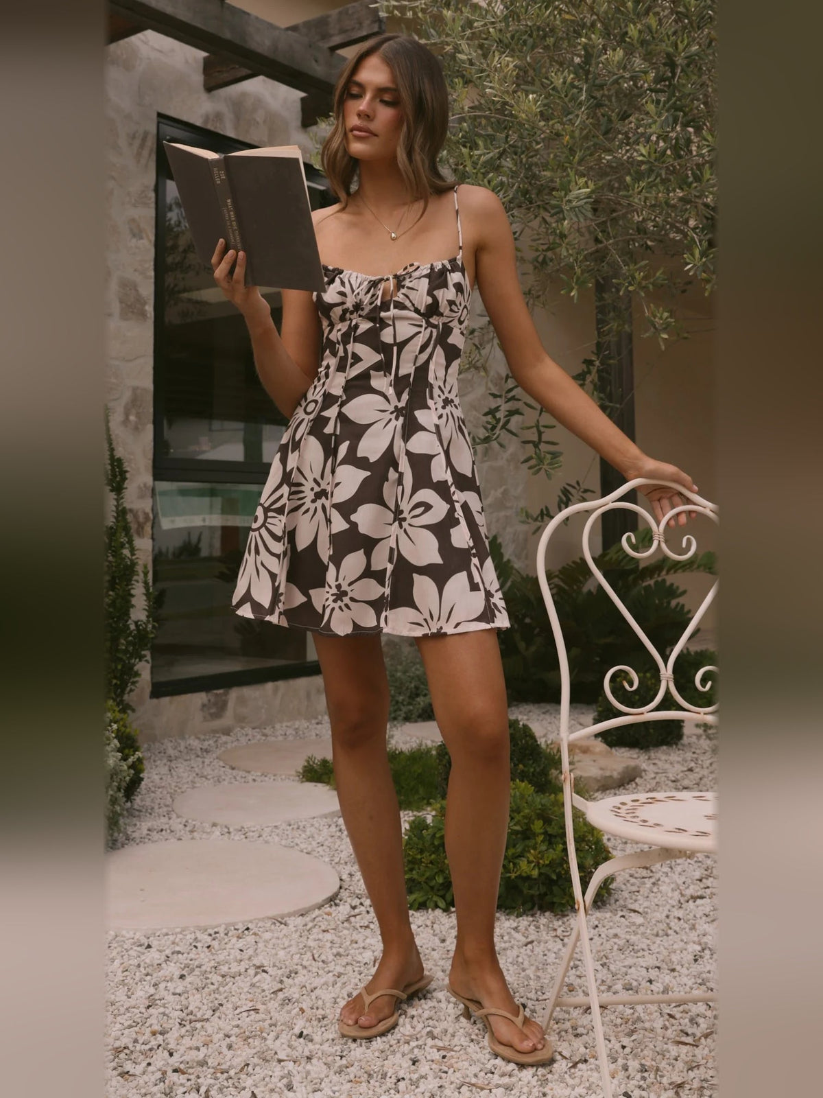 Chocolate floral mini dress with spaghetti straps, gathered bust, and skater skirt
