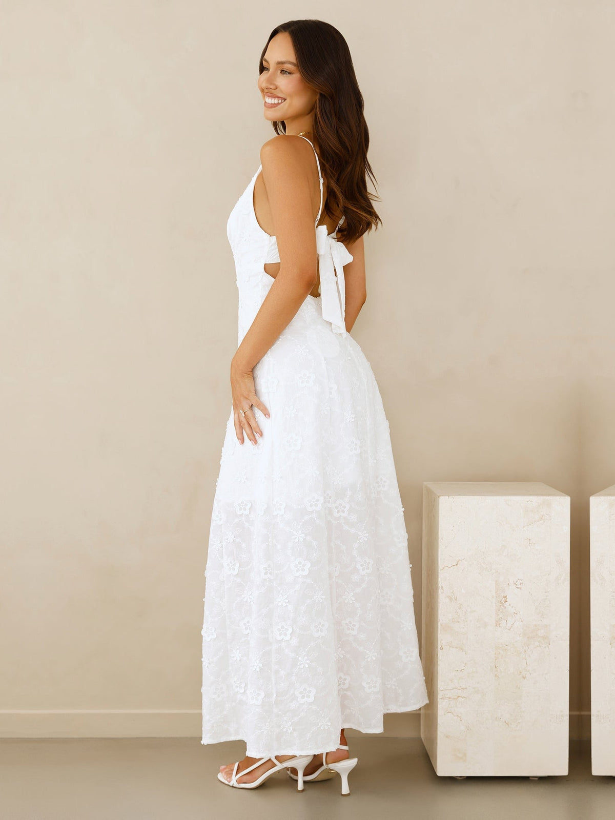 White a-line maxi formal dress with cutout detail, alternate view showing the hem