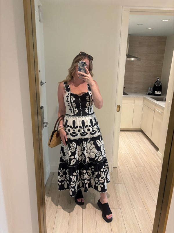 Black-and-white floral tiered midi dress, sleeveless with tiered ruffles and scalloped hem
