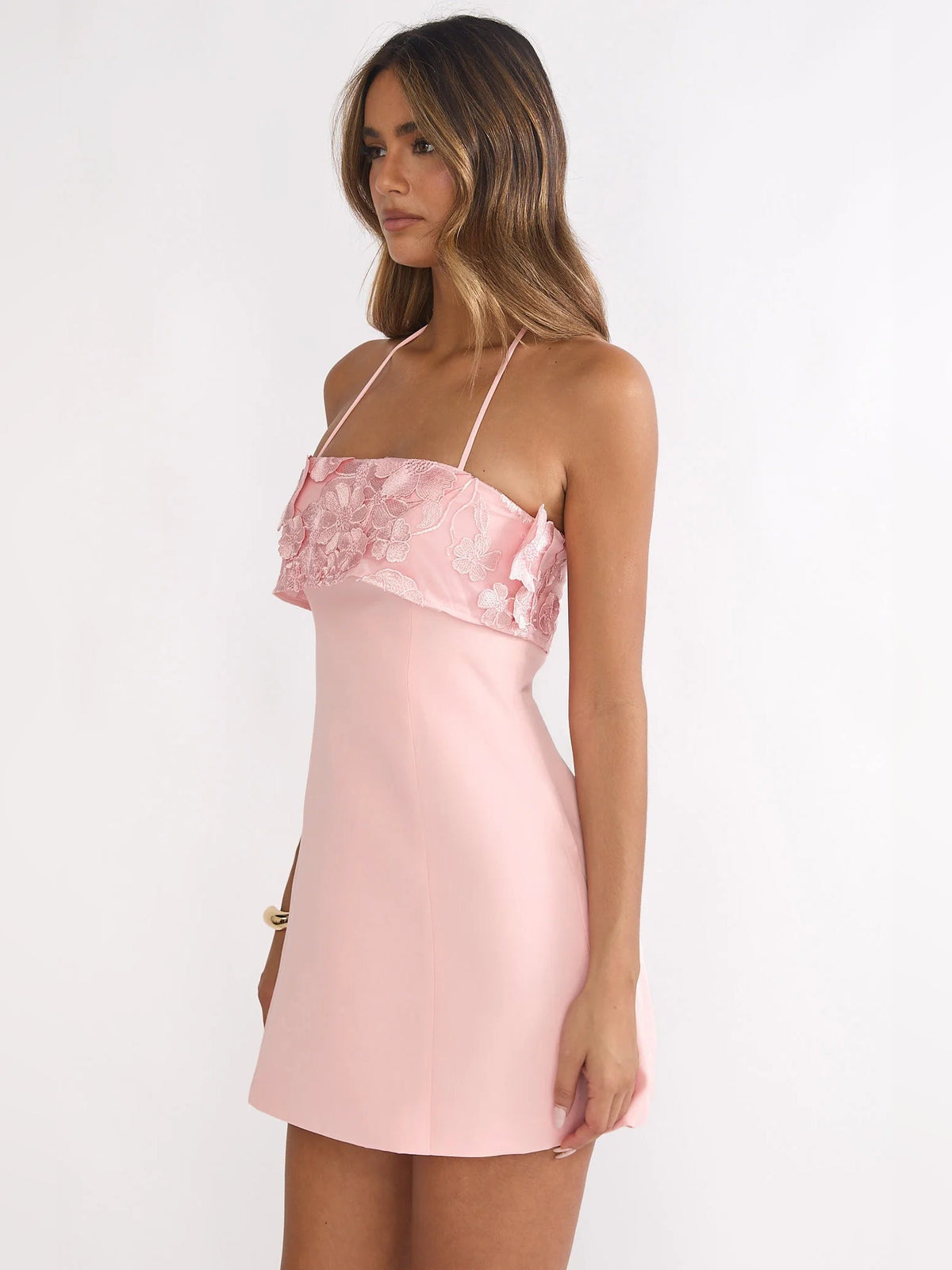 Blush mini homecoming dress with floral lace ruffle bodice and strappy back detail