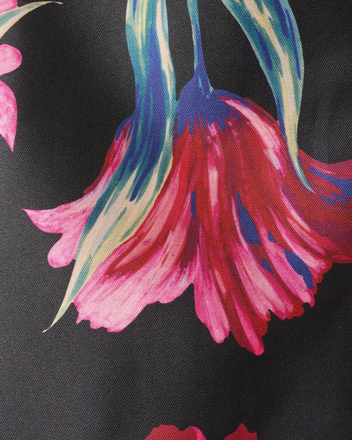 Black floral print fabric close-up with pink and blue flower motifs