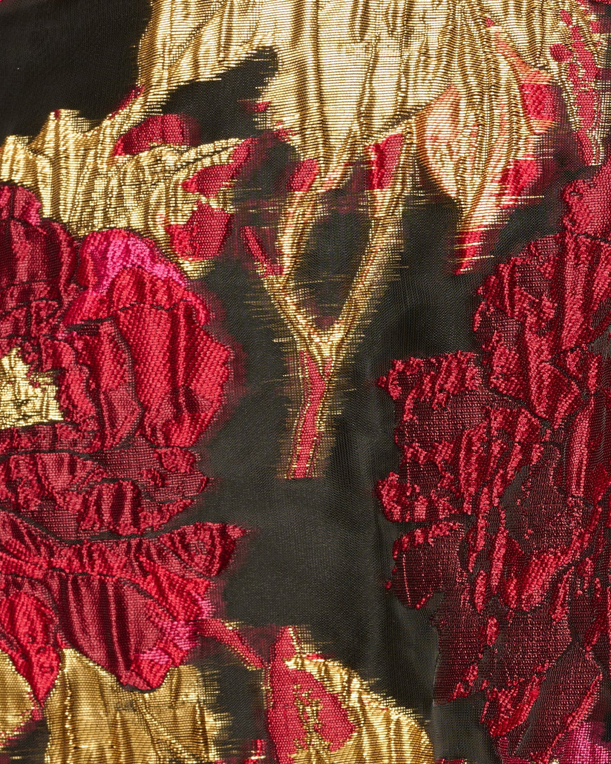 Floral fabric close-up with dark background and pink flower print plus gold accents