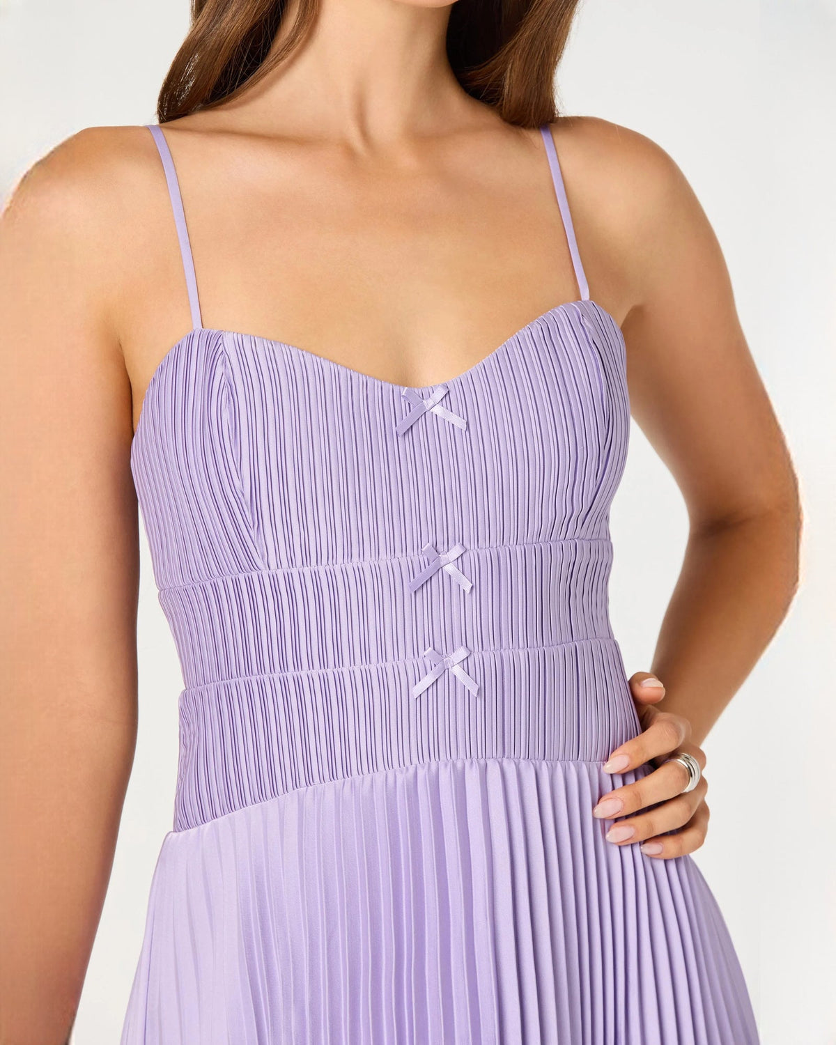 Lilac sleeveless chiffon midi dress bodice detail, vertical pleats and bow trim
