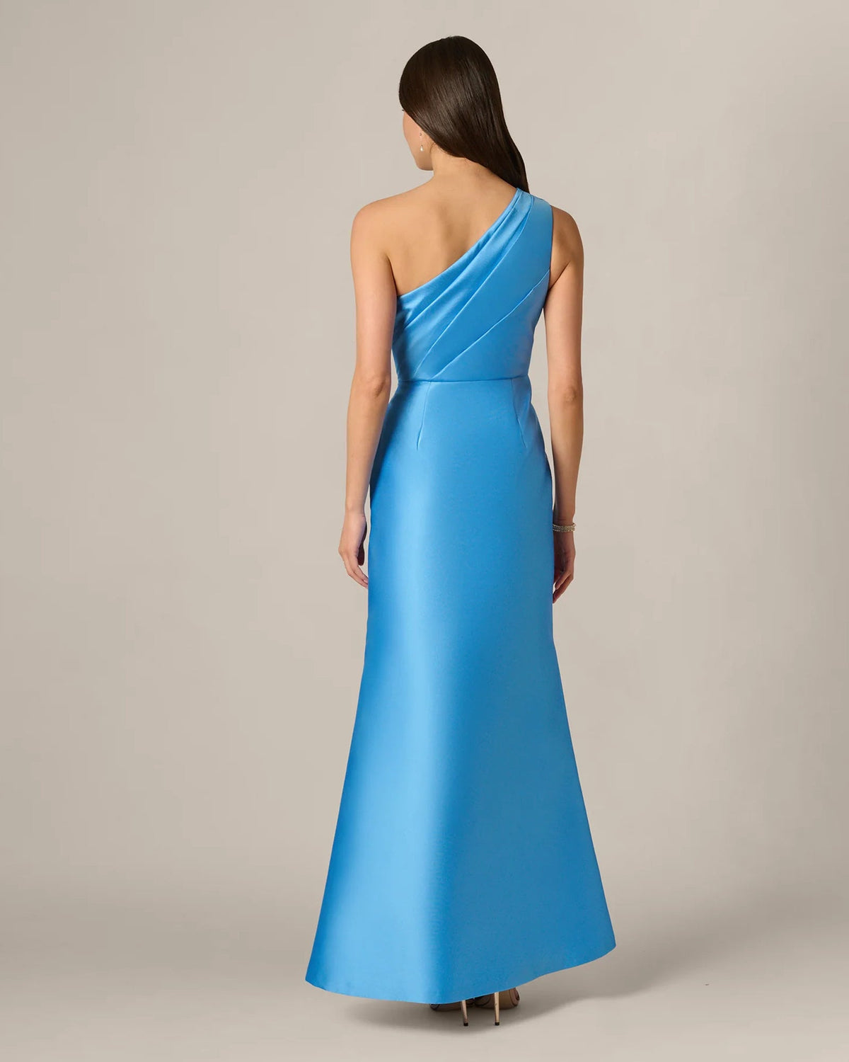 Sky blue one-shoulder maxi dress from back, with single-strap drape