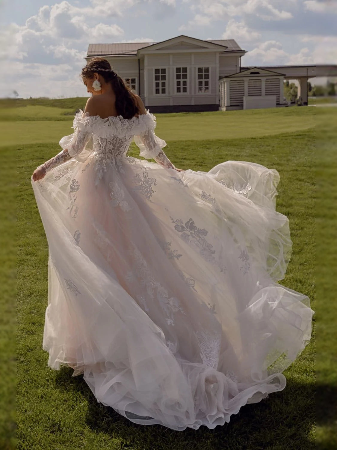 Ivory off-shoulder tulle wedding dress with floral appliqués and train