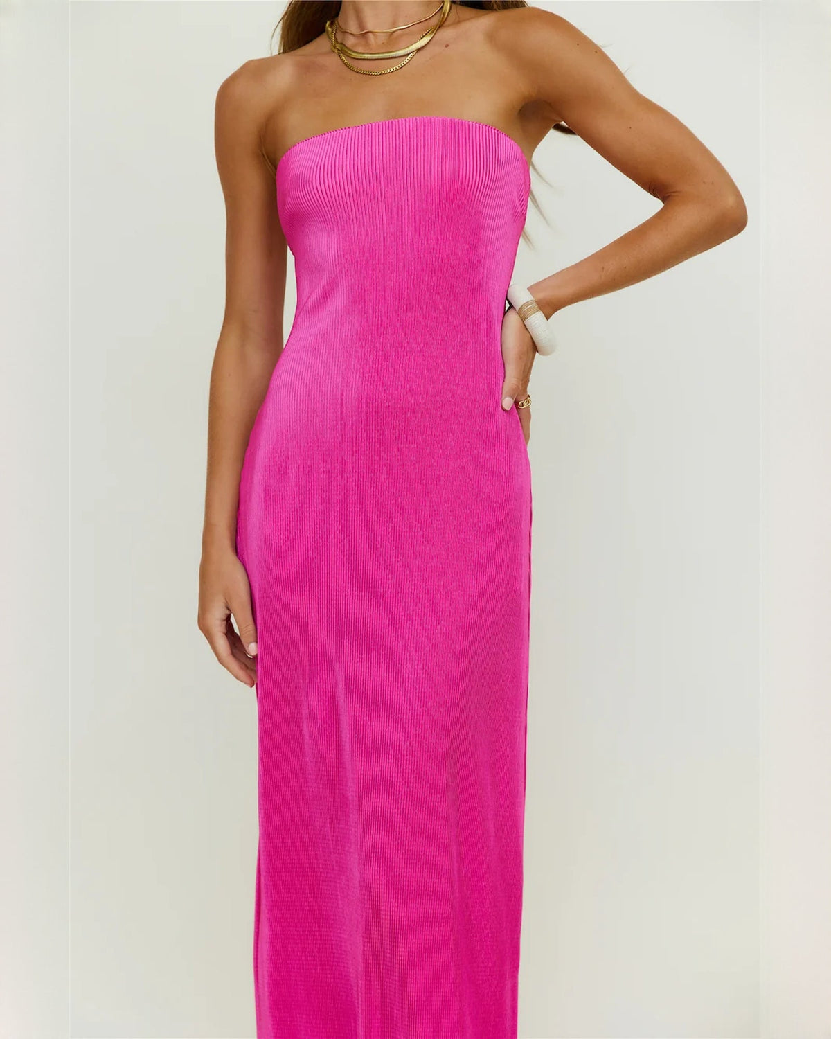 Close-up of bright pink strapless satin bodice and smooth fitted maxi skirt