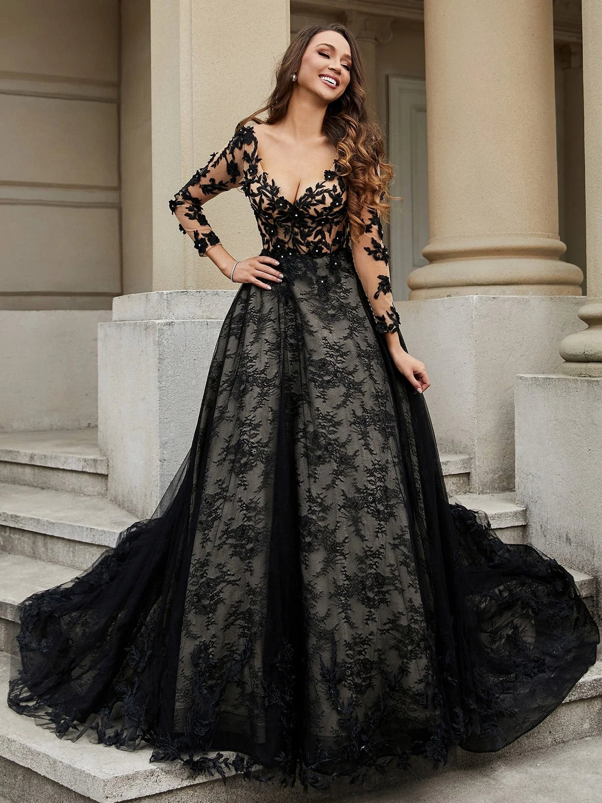 Black V-neck tulle wedding dress with floral applique bodice and dramatic A-line volume