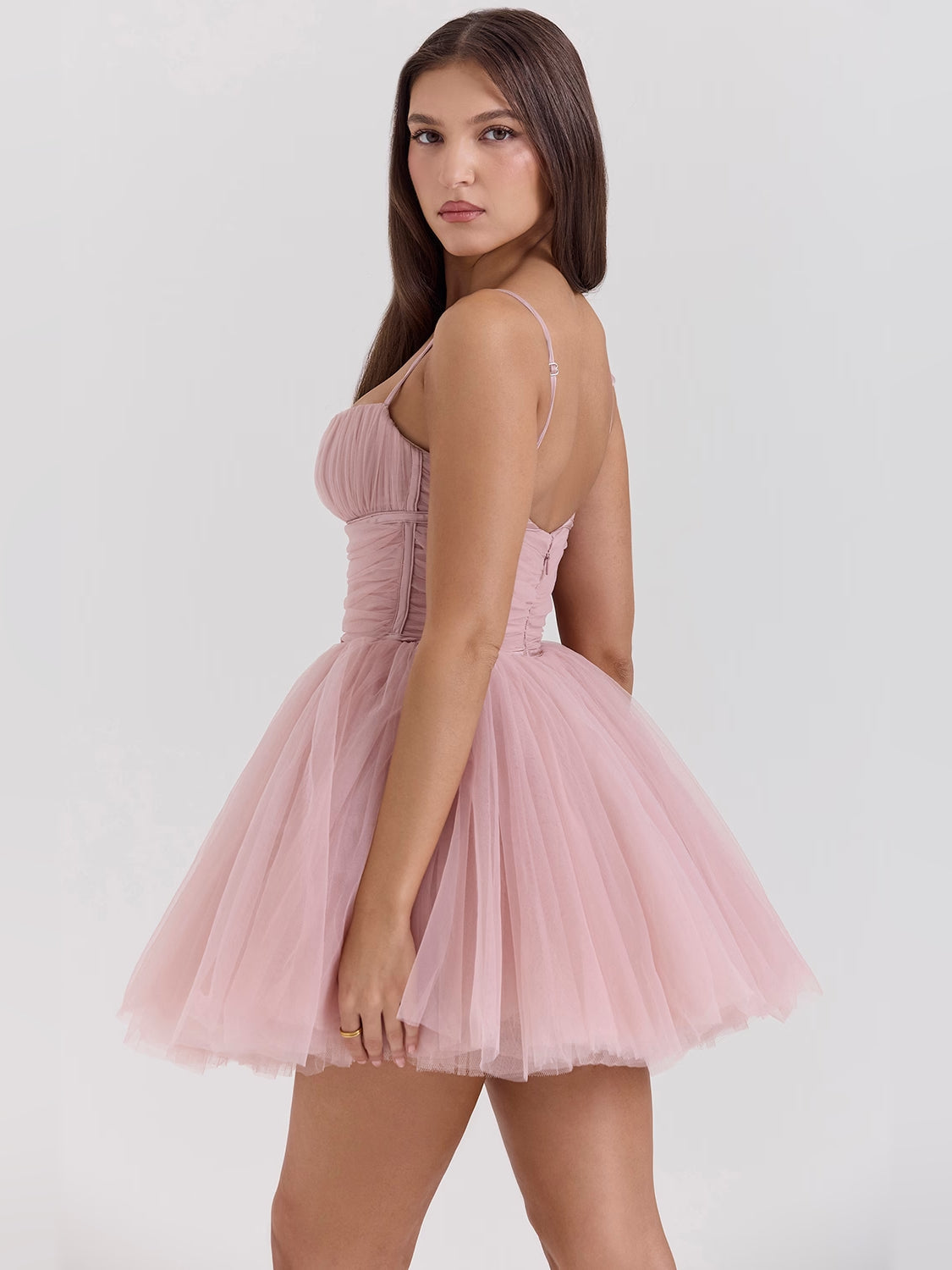 Blush pink mini tulle dress viewed from the side, spaghetti straps and layered skirt