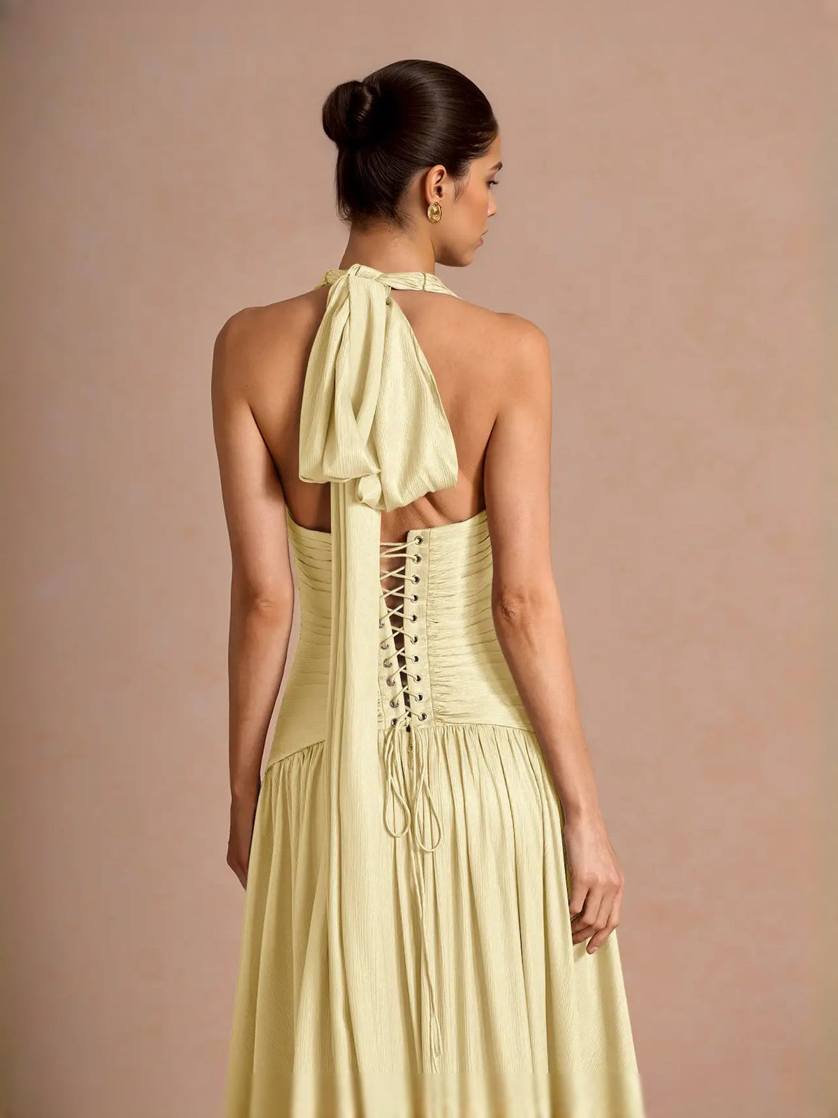 Pale lemon open-back maxi prom dress with ruched corset and braided-lace back detail