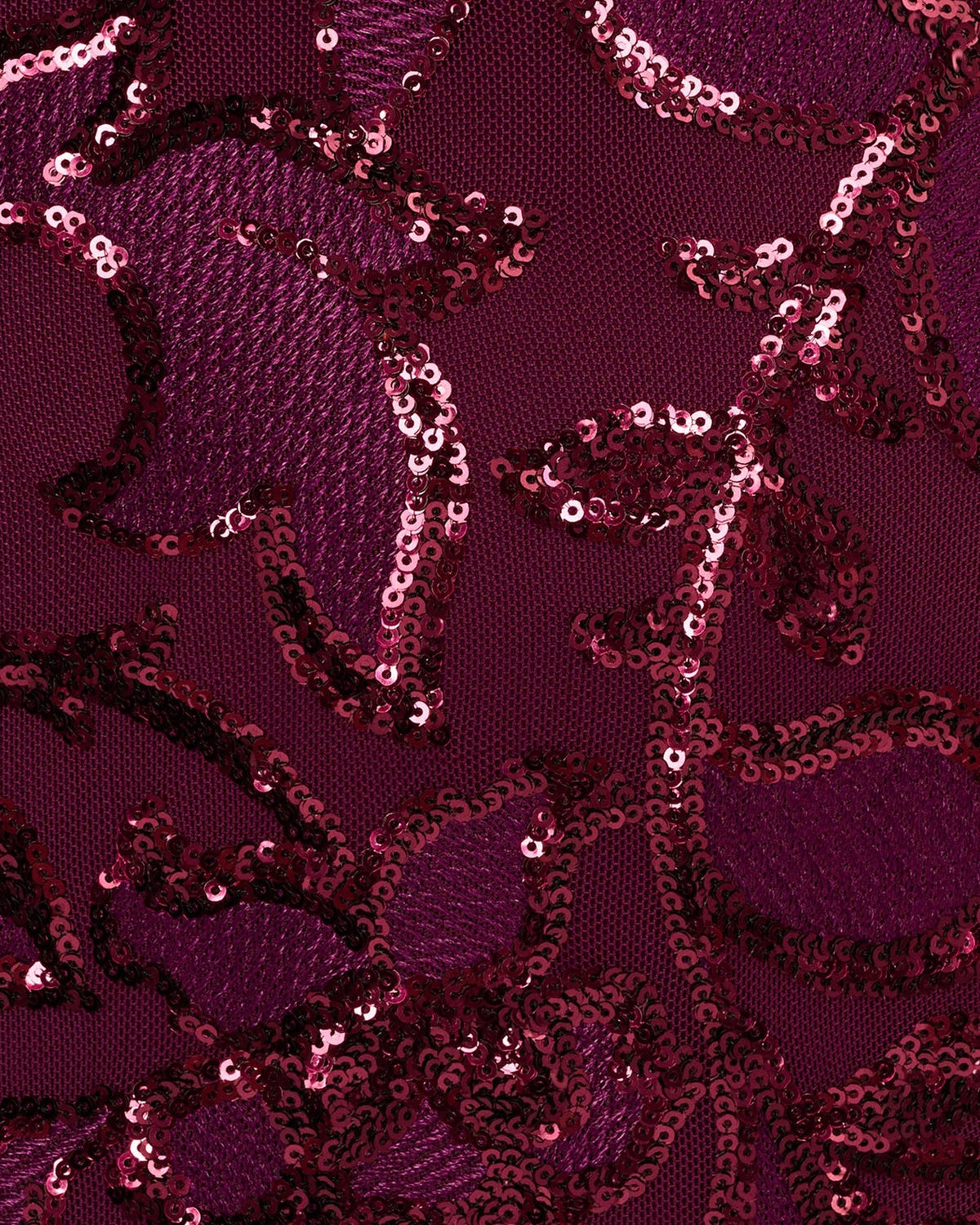 Burgundy sequin fabric overlay with floral scroll embellishment texture