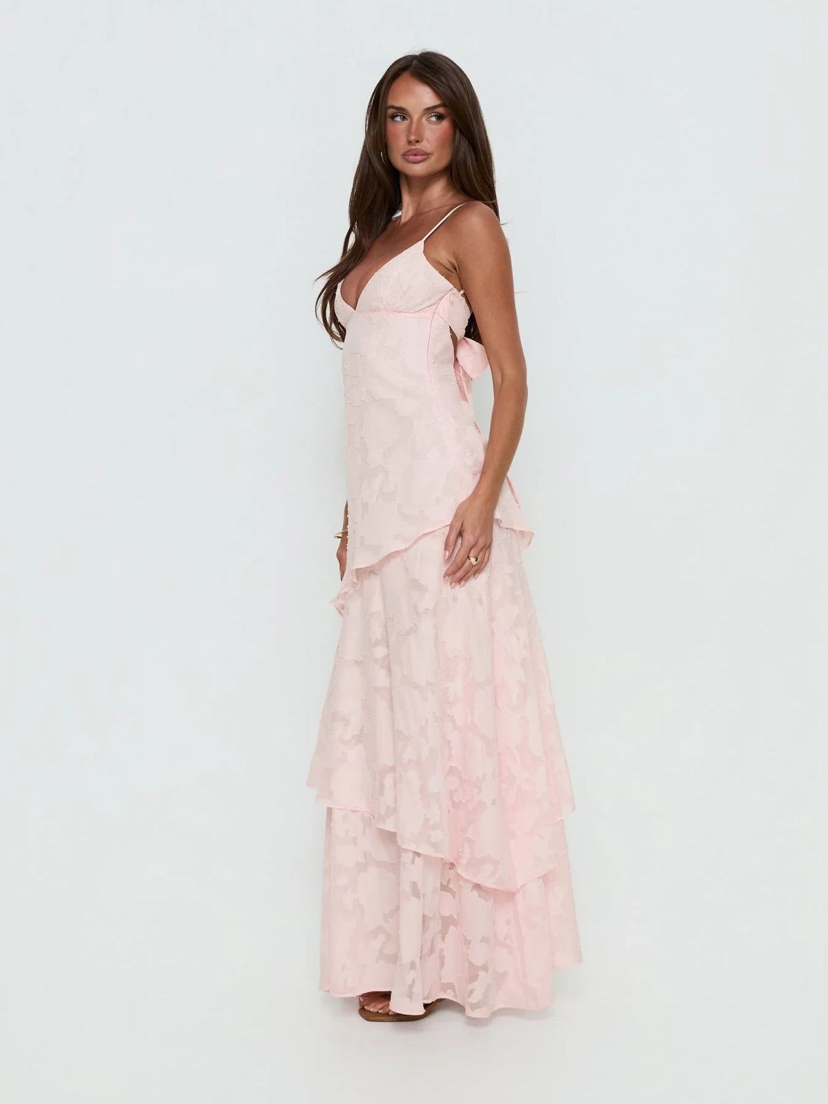 Pink a-line maxi formal dress with ruffle details, alternate full-length view showing the hem