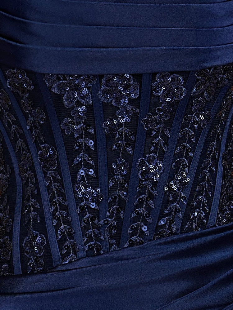 Navy satin mini dress close-up showing vertical beaded corset pattern and draped ruching