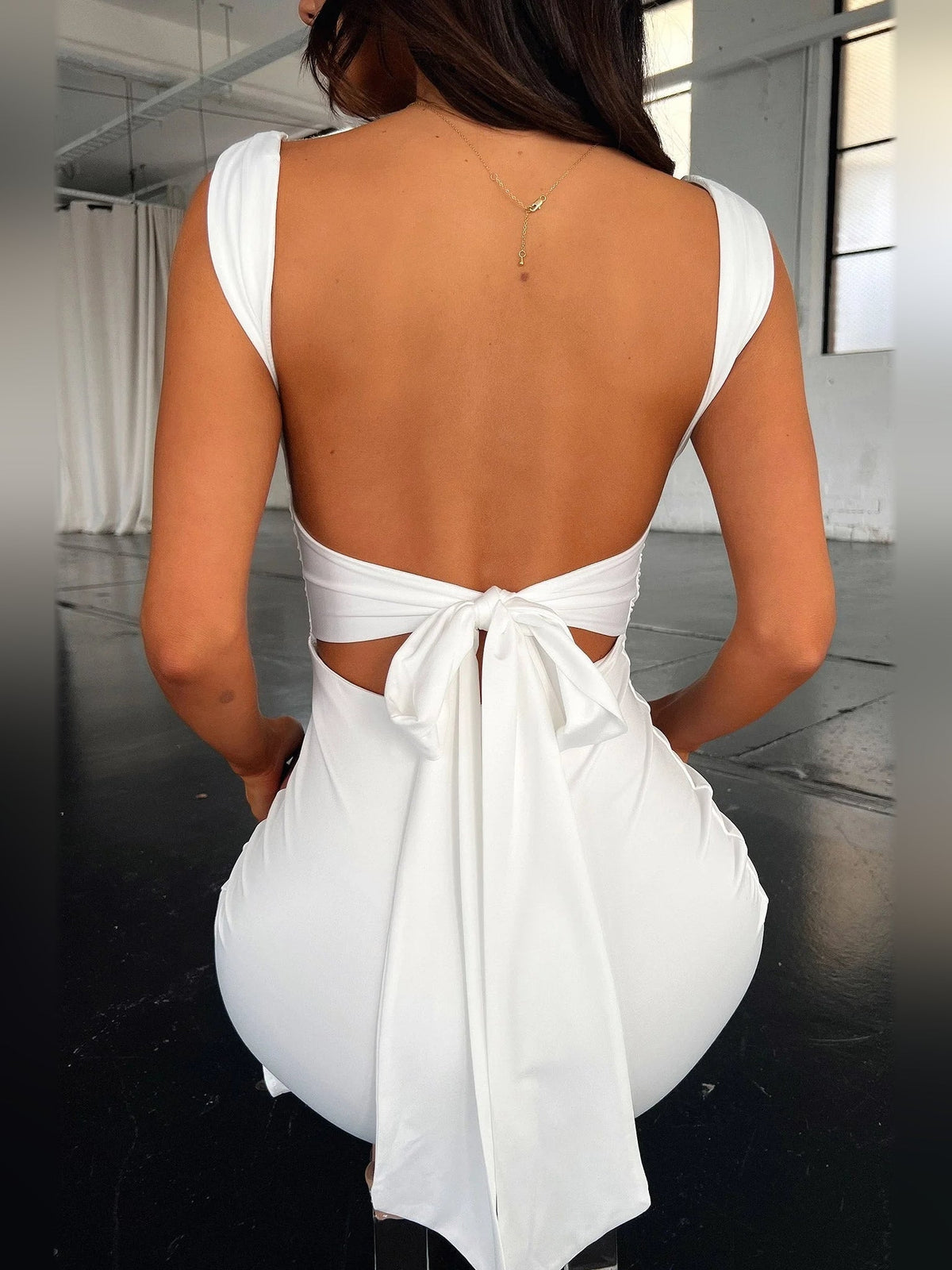 Ivory white backless ruched mini dress with square straps and tied bow detail