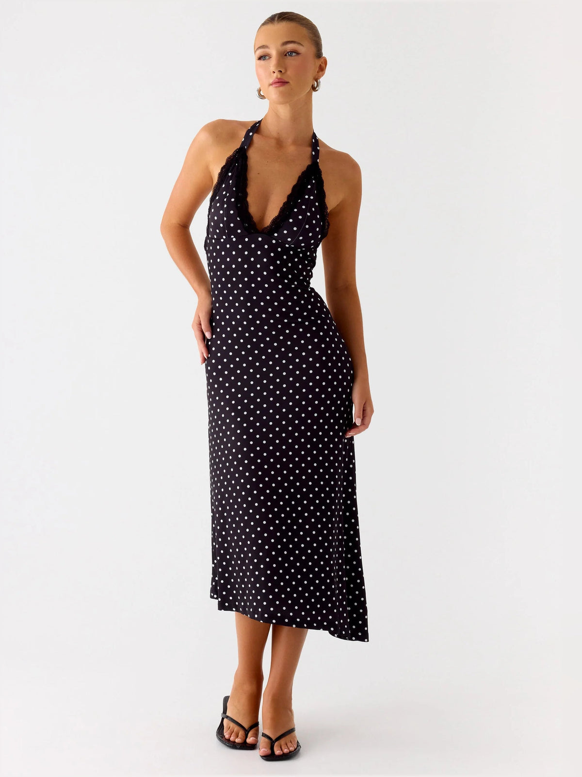 Black polka-dot halter midi dress with deep V neckline and fitted bodycon silhouette