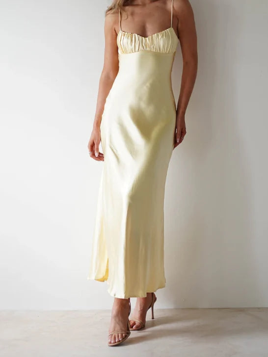Yellow satin maxi bridesmaid dress with thin spaghetti straps and gathered bust, side slit