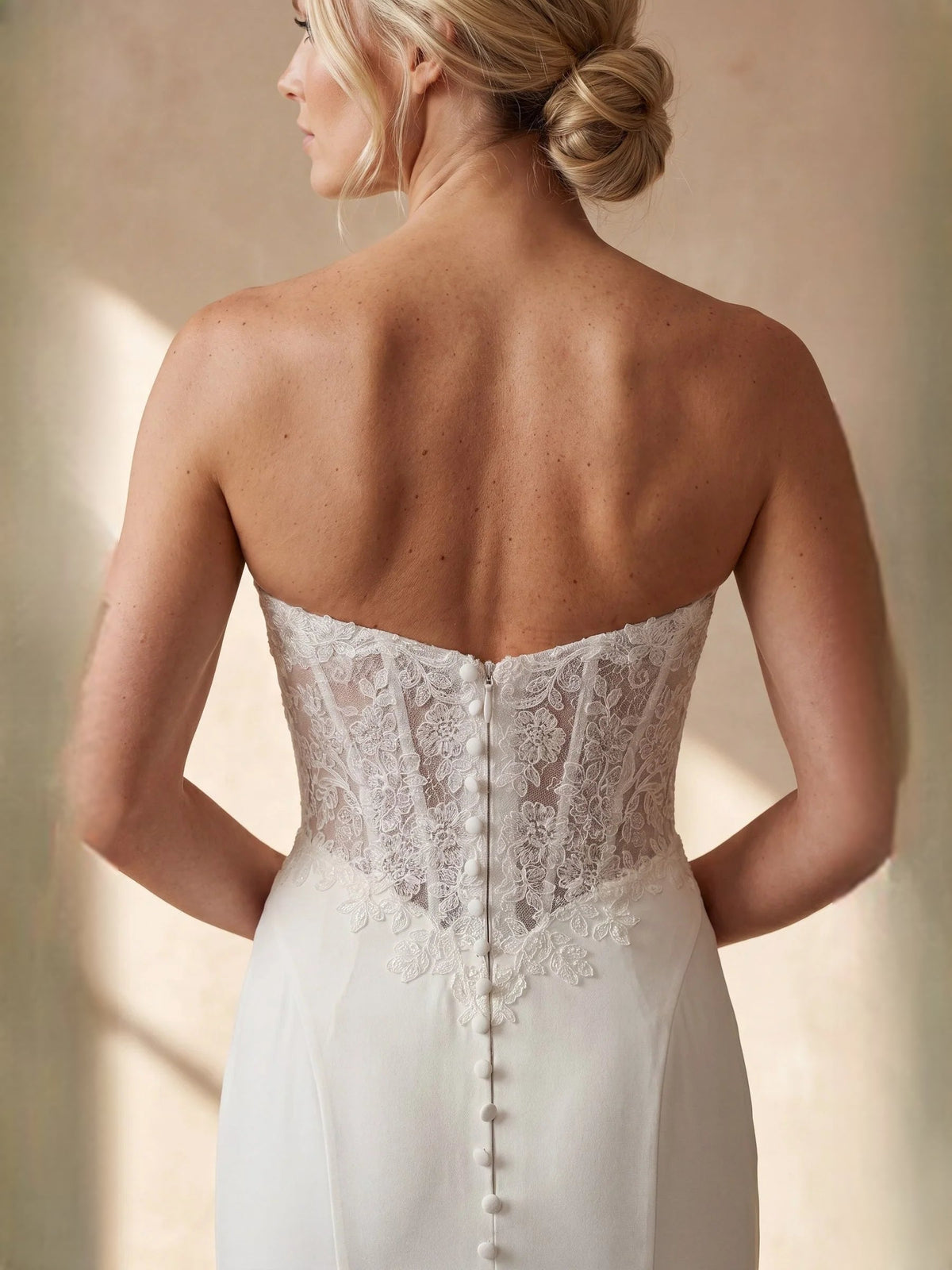 Ivory corset-back lace wedding dress with buttoned back detail and mermaid skirt