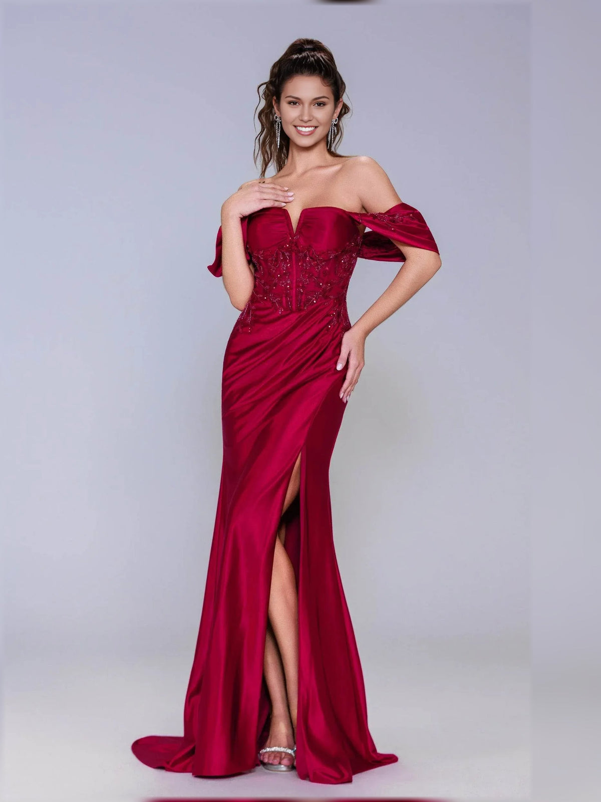 Deep red off-shoulder formal dress with ruched bodice, draped sleeves, and side slit.