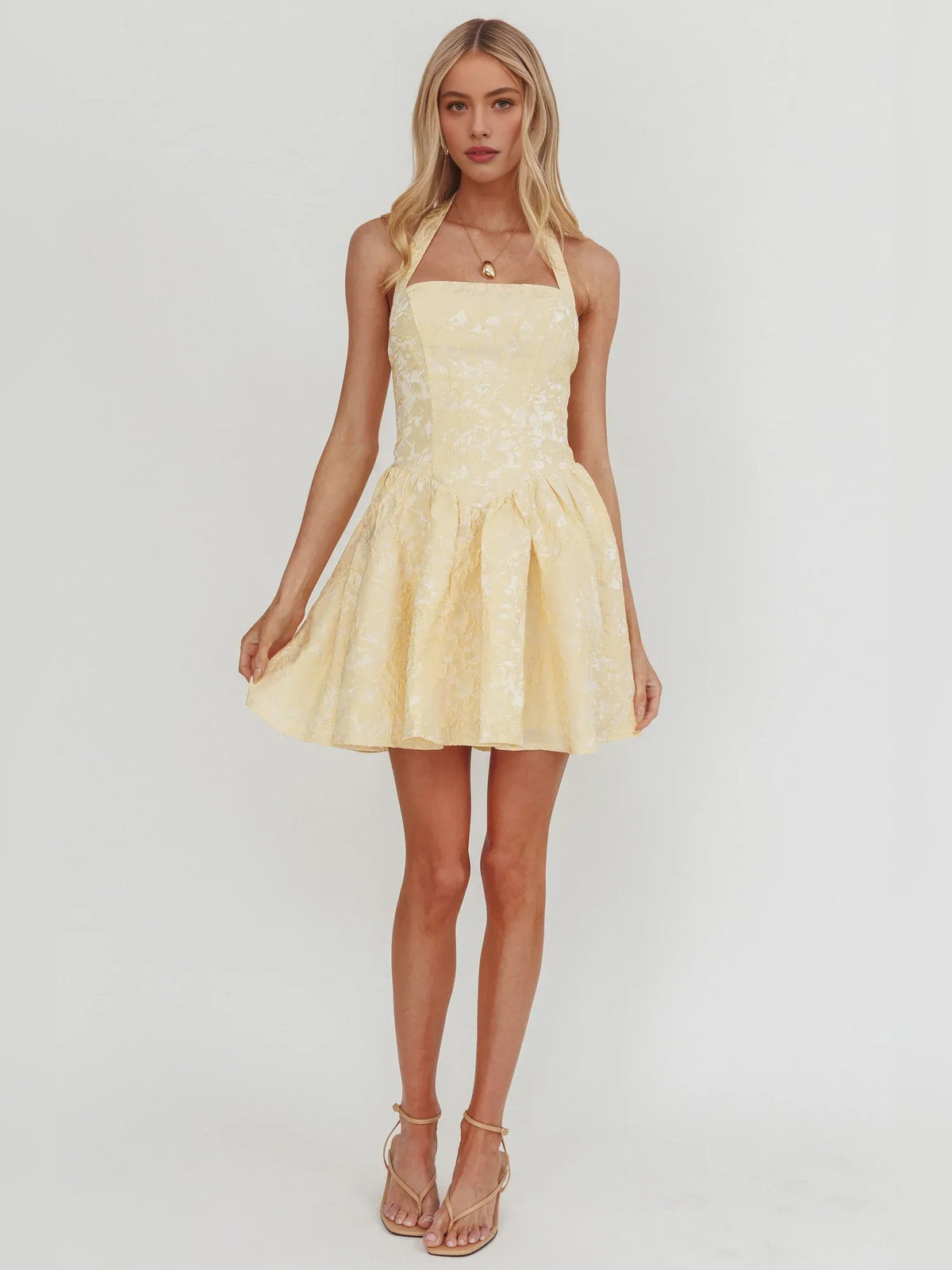 Pale lemon halter-neck corset mini dress with flared A-line skirt and textured overlay
