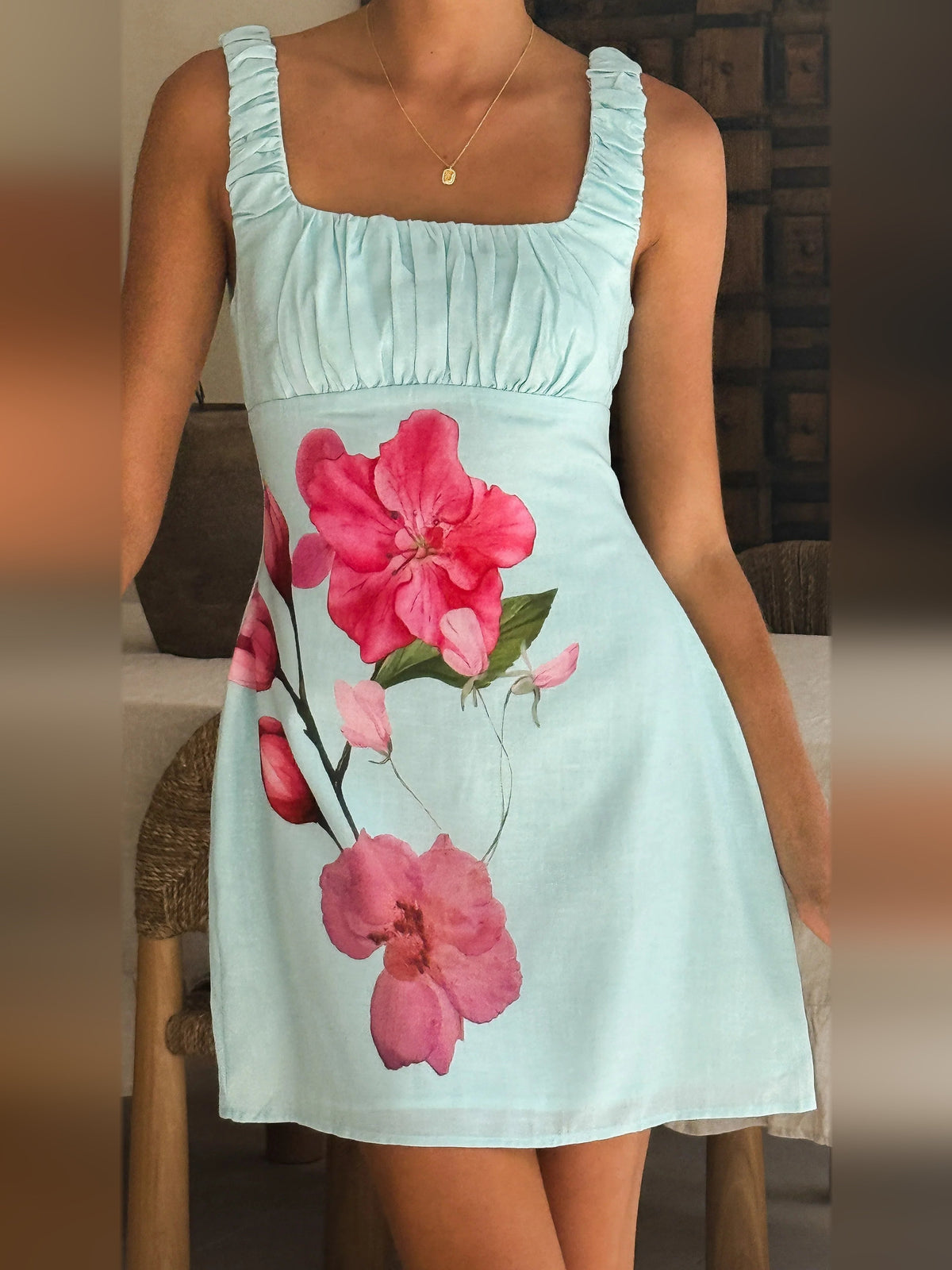 Light blue floral mini dress with ruched square neckline and ruffle sleeves
