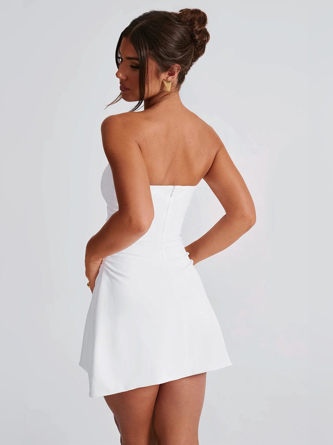 Ivory strapless mini homecoming dress, back view with gathered waist and flare