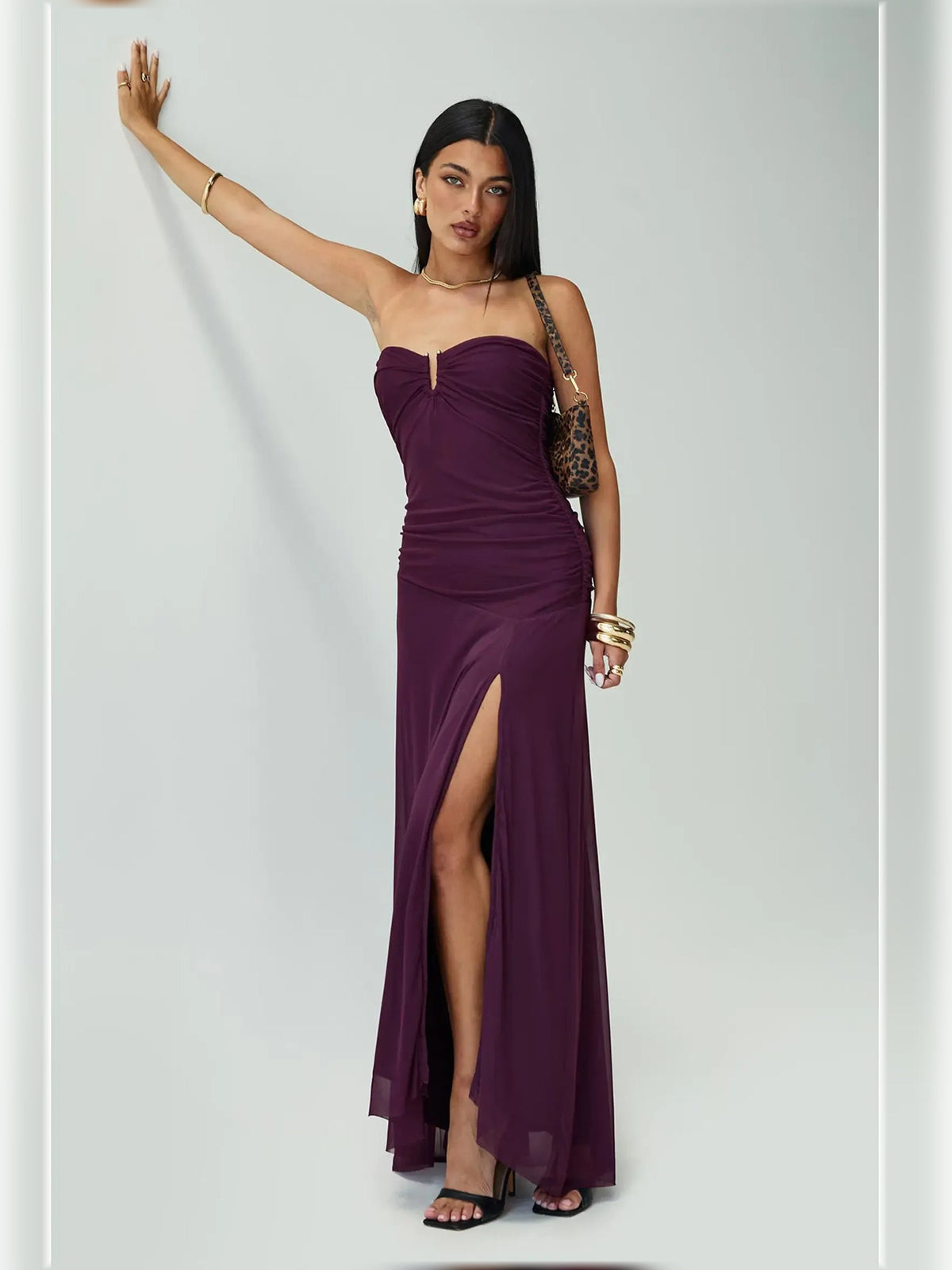 Purple strapless ruched slit maxi dress with front keyhole detail and long flowing skirt