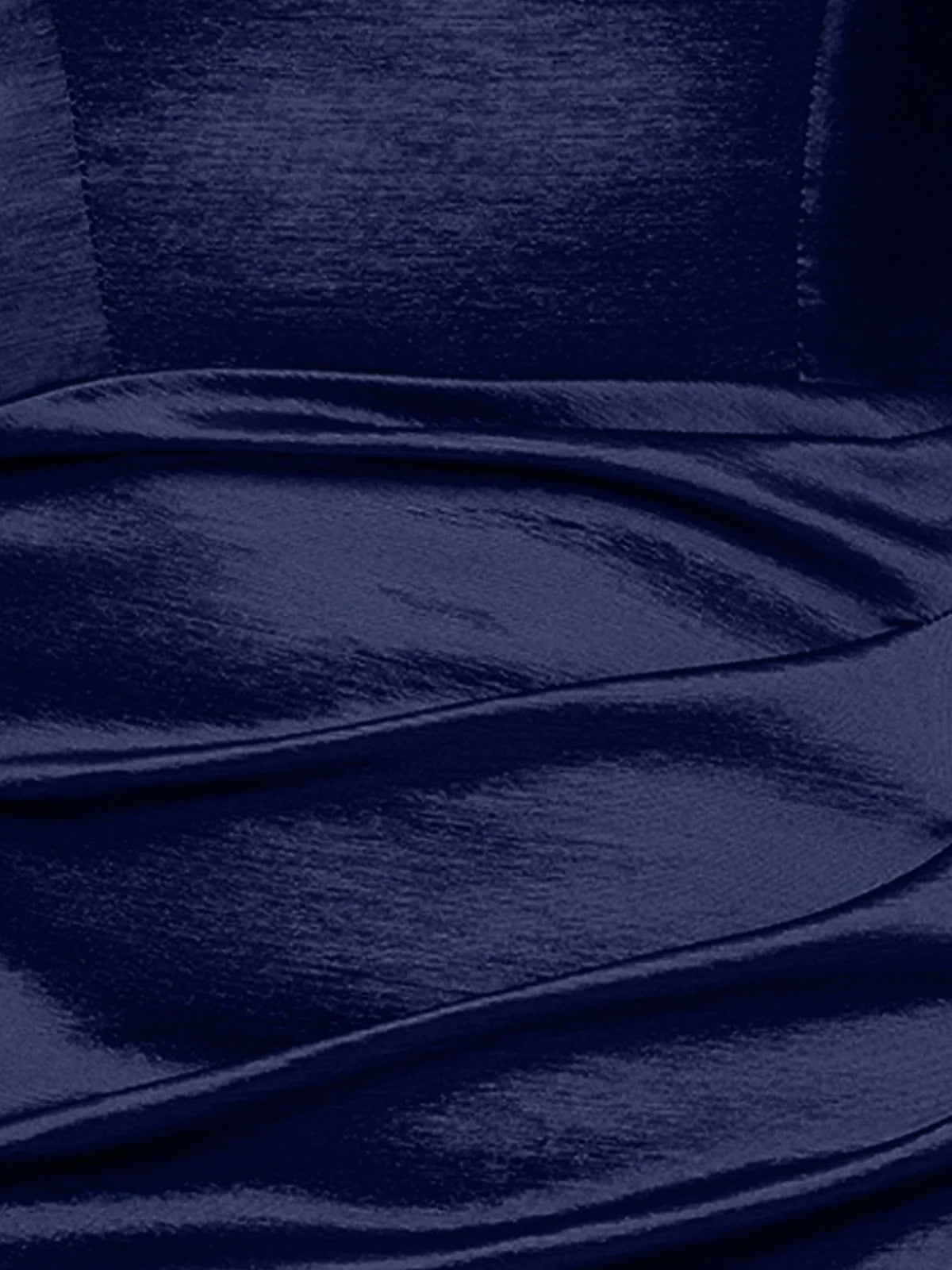 Close-up of dark navy satin fabric with smooth sheen and gathered folds