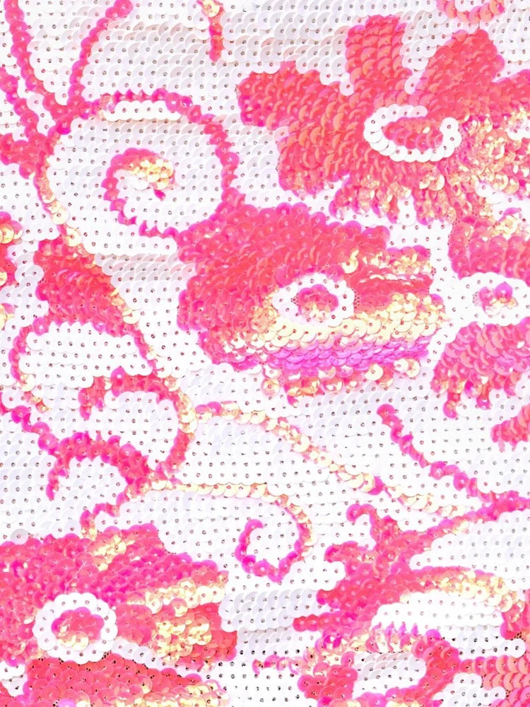 Close-up of pink and white sequin floral pattern on a mini dress