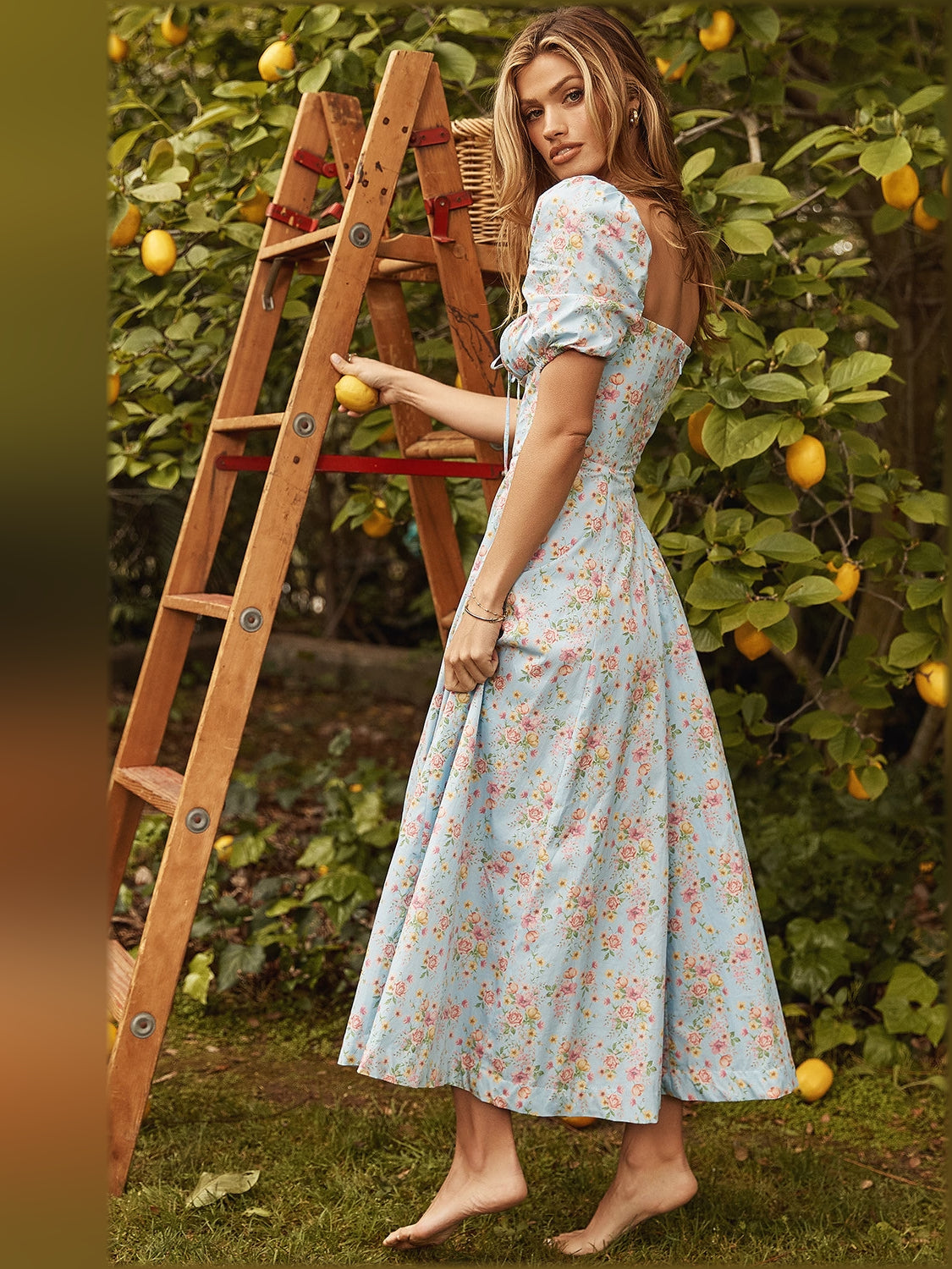 Floral midi dress with puff sleeves and fitted bodice, worn with side slit