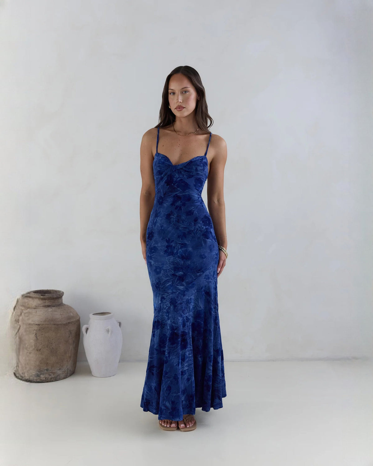 Navy sleeveless mesh maxi dress with spaghetti straps and draped fitted bodice.