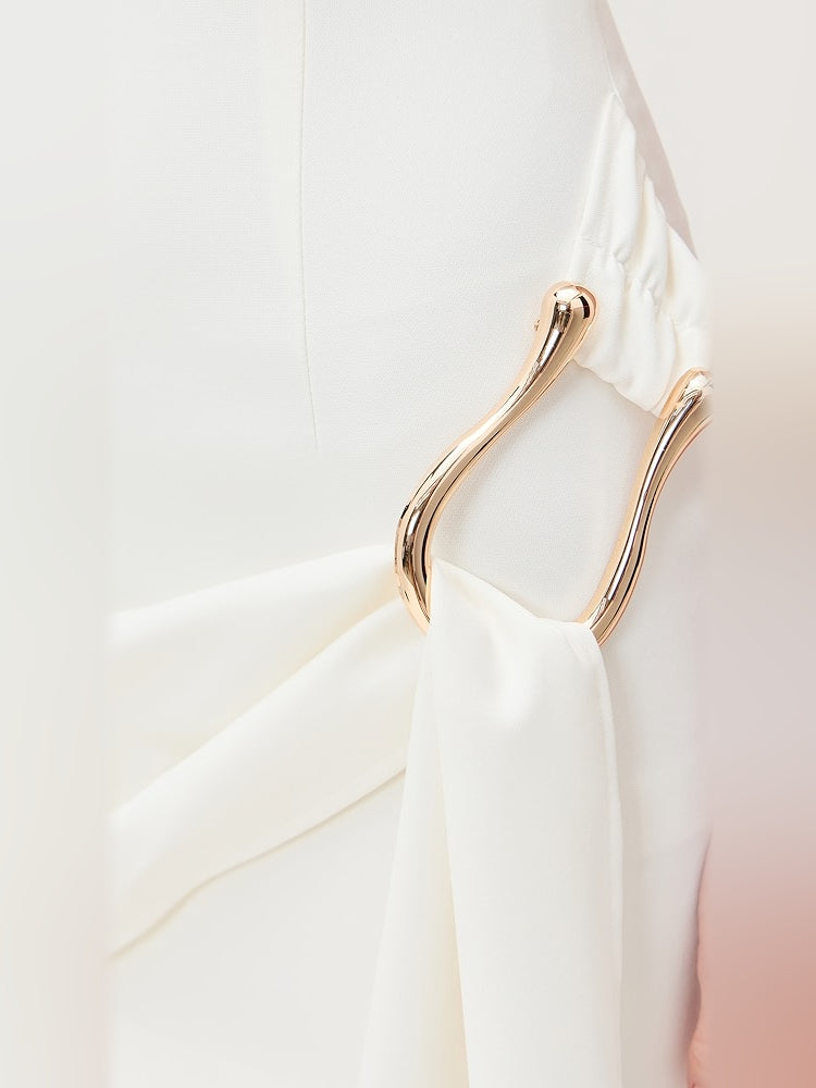 Close-up of white draped waist with gold-tone O-ring hardware detail