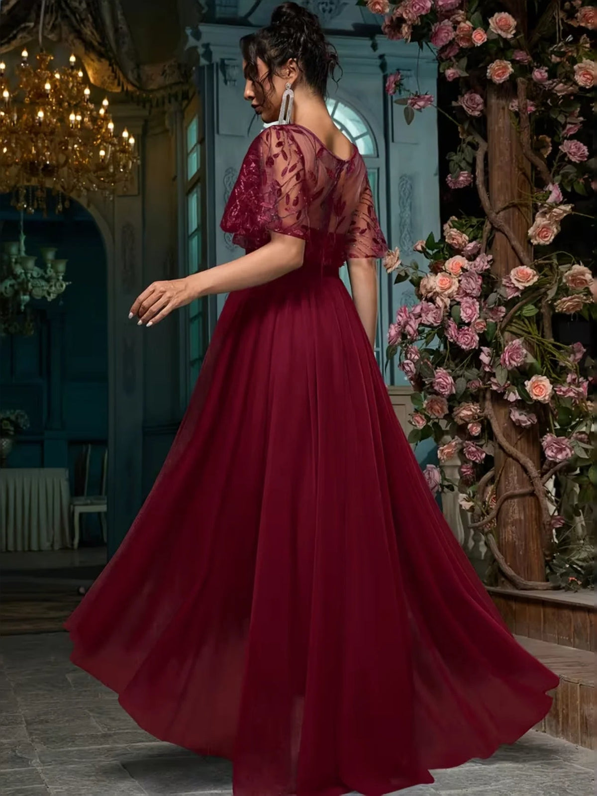 Cabernet red A-line maxi prom dress with embroidered ruffled short sleeves and flowing tiered skirt.