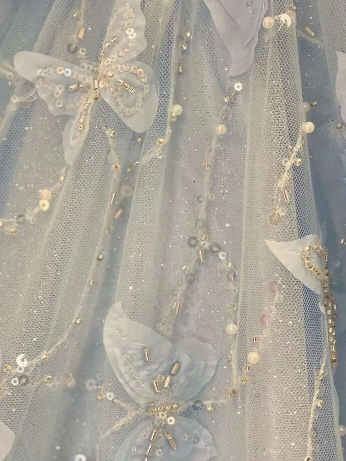 Sky blue satin prom dress close-up with sequined mesh and beaded floral appliqués