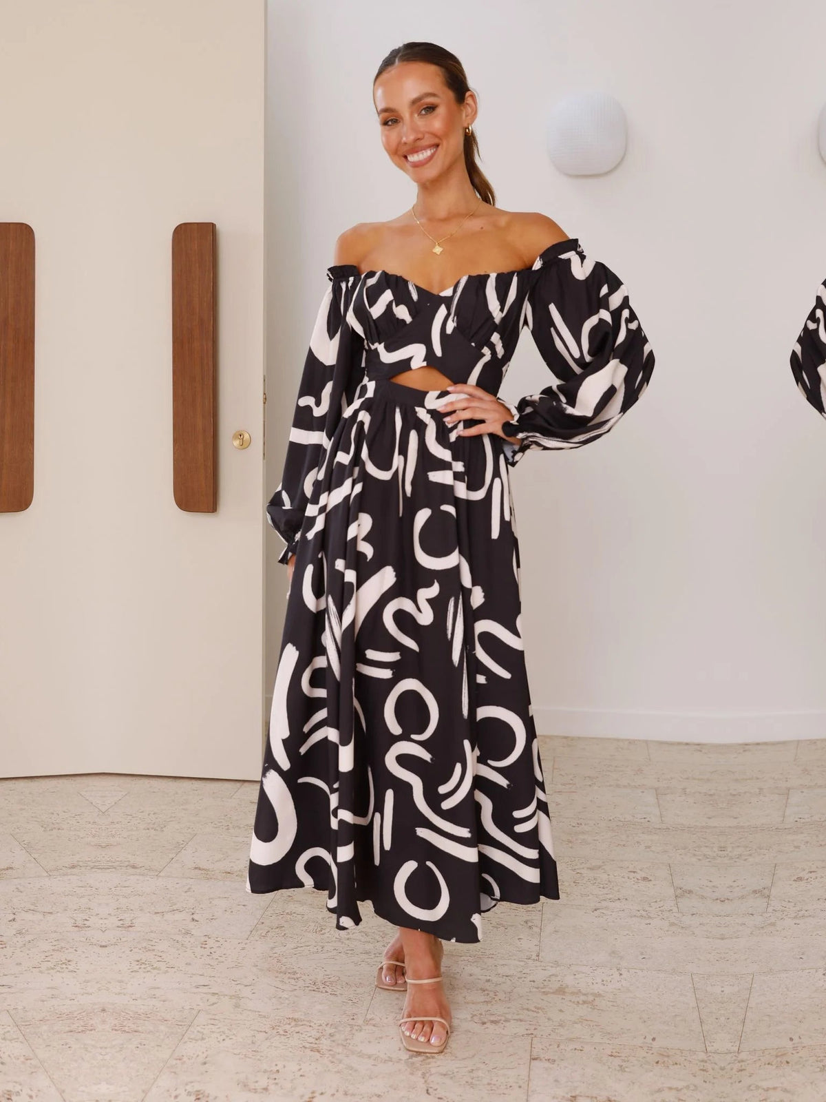 Black a-line maxi formal dress with skirt slit, alternate view showing the hem
