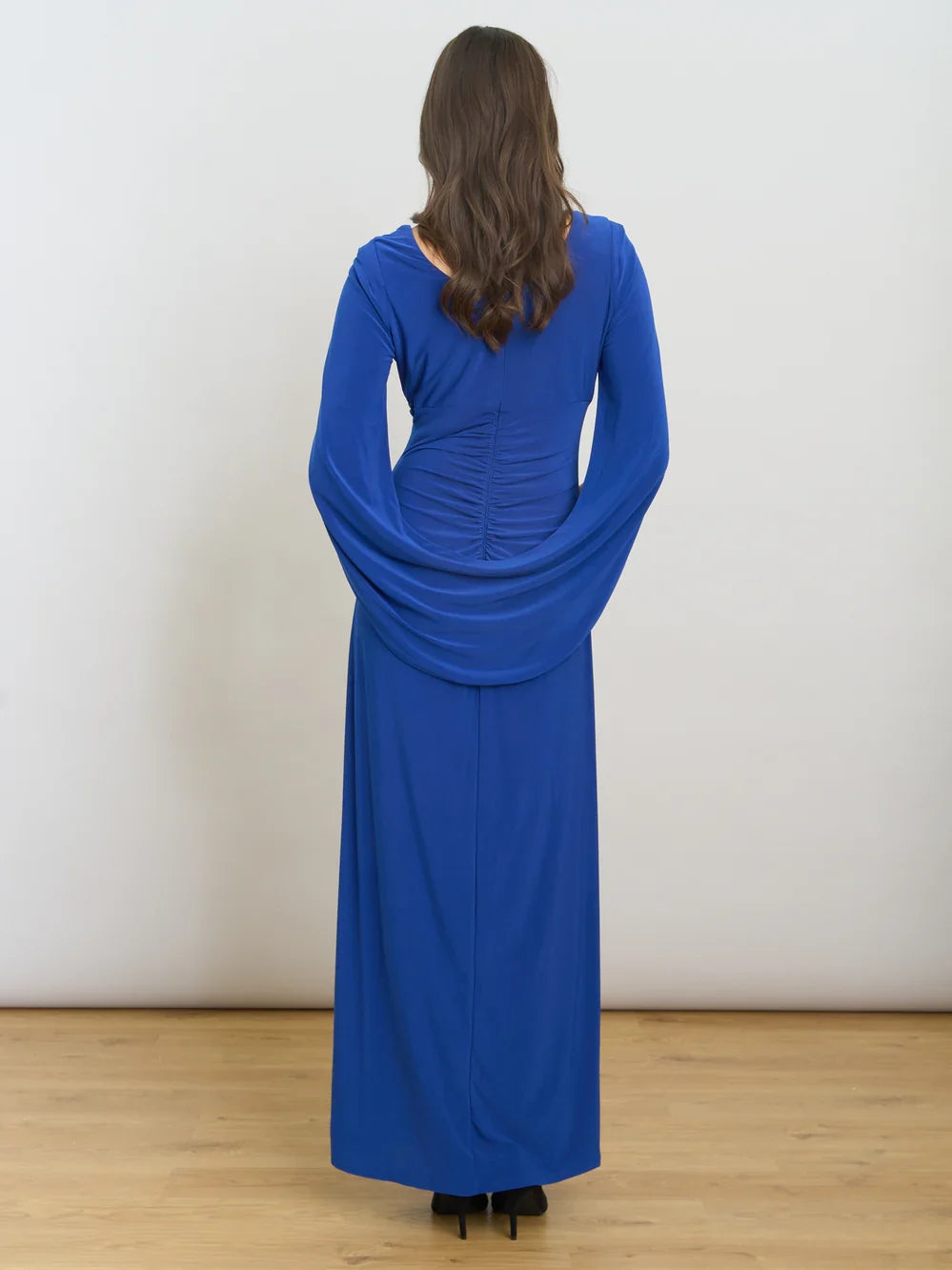 Cobalt blue ruched draped sheath maxi dress shown from back with long sleeves