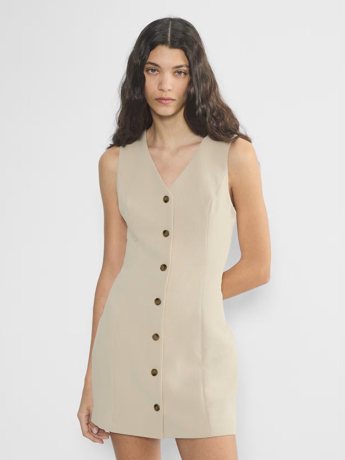 Beige mini crepe homecoming dress with sleeveless V-neck and button front