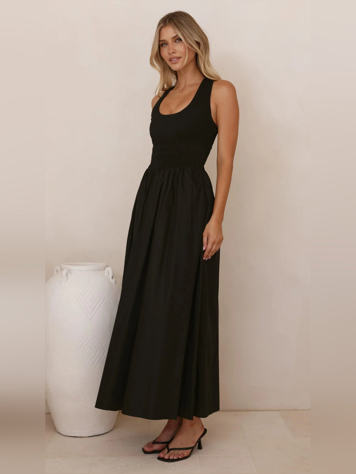 Black a-line maxi formal dress with halter neckline, alternate view showing the hem