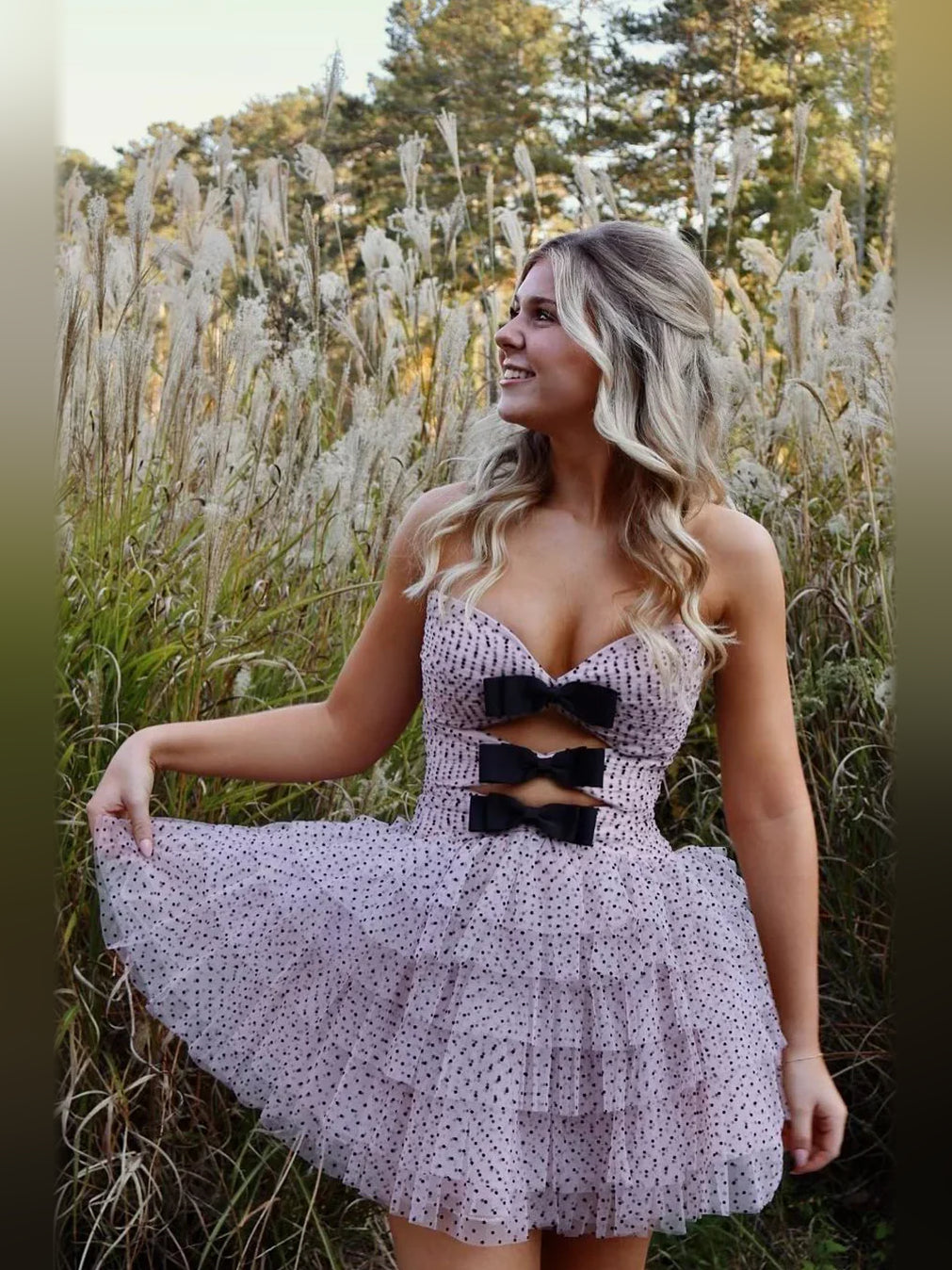 Lavender/pink mini tulle dress with sweetheart neckline and black bow cutouts, flared skirt